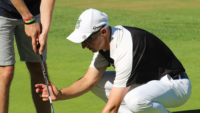 Golfer being instructed how to putt