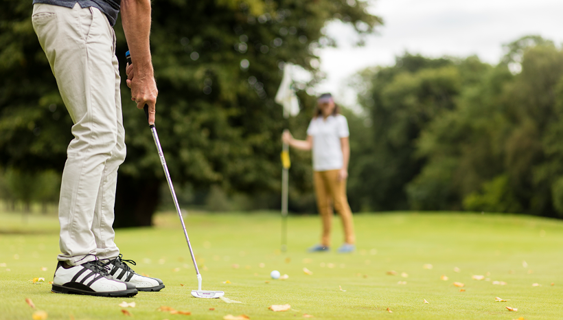 Putting shot on green, golf course, golf club