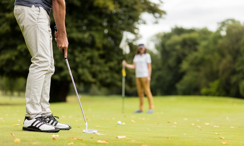 Putting shot on green, golf course, golf club
